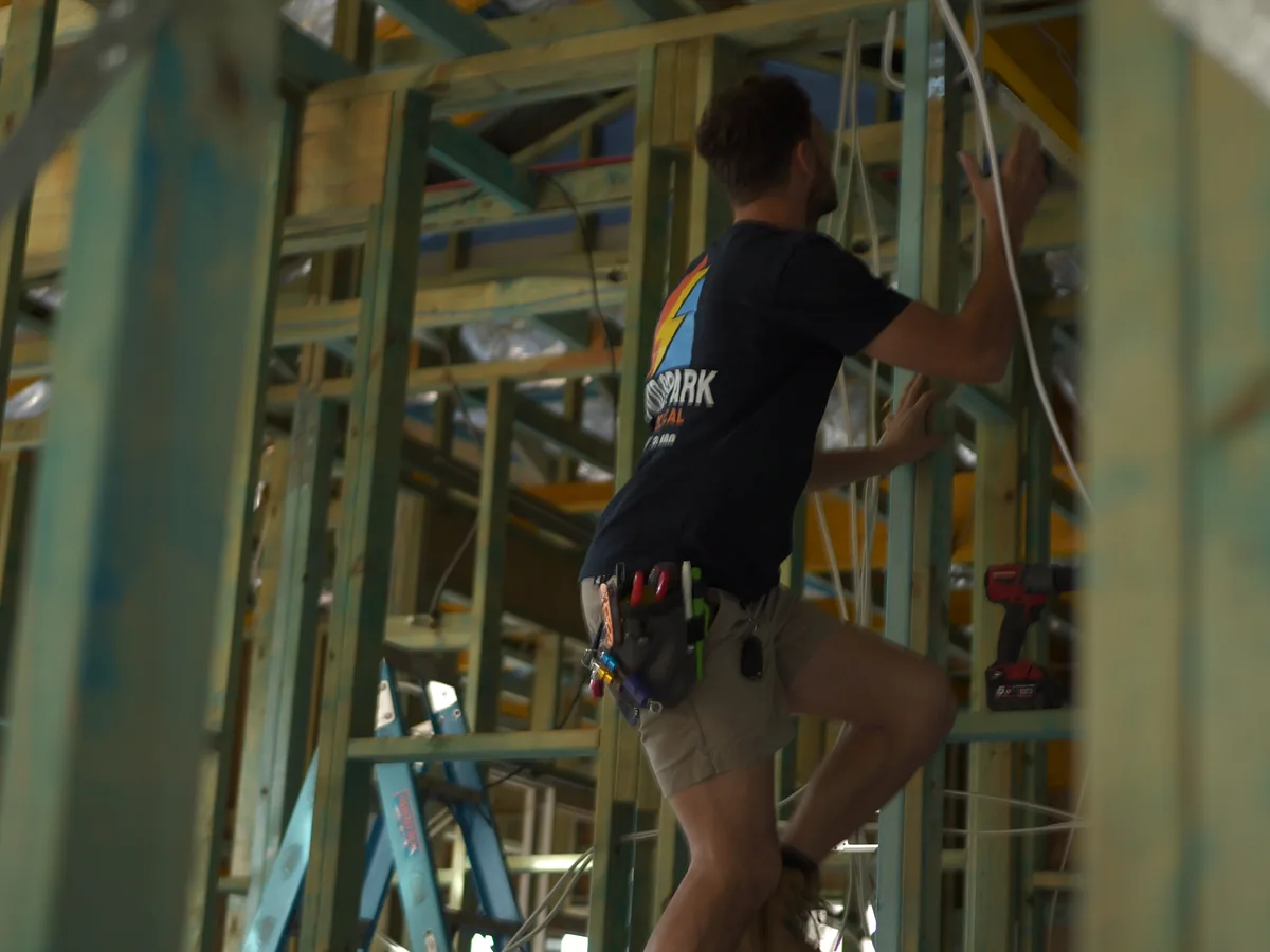 Vivid Spark electrician completing an installation at height